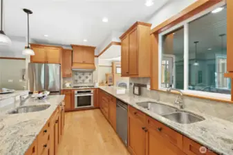 Gorgeous crafted kitchen with solid VG fir cabinets, granite, stainless appliances! Gas range with custom tile detailing.