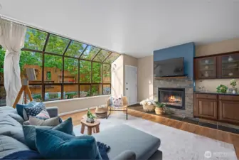 Open, spacious, and tranquil living space with wood burning fireplace.