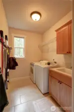 Laundry with deep sink, upper and lower cabinets, rod & shelf and the handy tool hanging rail.
