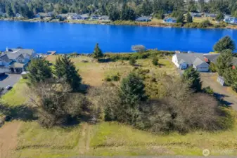 Lot is nicely open towards lake - keep or remove rear vegetation for privacy.