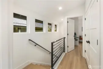 Stair case has plenty of natural light, hardwood floors throughout upper level