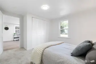 Primary bedroom with partial view to the Hood Canal and Olympic Mountains.