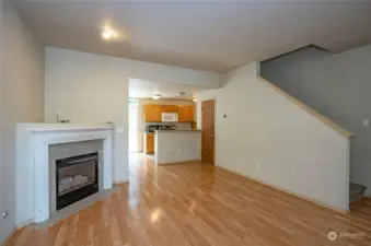 A view into the kitchen with the staircase conveniently positioned to the right, leading to the upper level of the home.