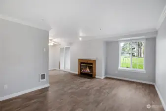 Open Living Room and Dining area with fireplace and slider to back private patio and storage.