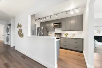 Updated kitchen counters, plenty of light and IN UNIT FULL SIZED LAUNDRY tucked down the hall