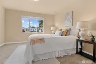 The window in the primary bedroom lets in wonderful natural light.