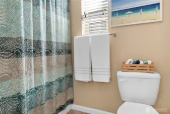 The upper hall bath offers a tub/shower combo unit.