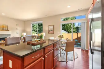 A kitchen island with granite countertop adds to the entertaining space.