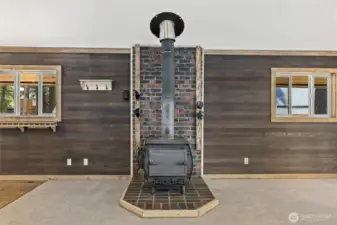 Freestanding wood burning stove.  On both sides there are pegs for drying your gloves and mittens in the winter.