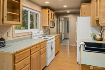 Light and bright kitchen looking towards den/office on the main floor.