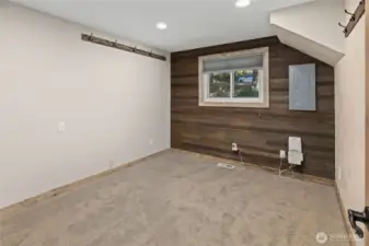 Downstairs bedroom with wood plank wall.