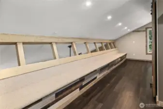 Upstairs sitting space, goes the entire length of the loft.  Great space for playing games, puzzles. reading a good book or just hanging out.