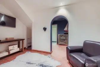 Lower level wine cellar accessed from a spiral staircase off the main entry hall or down a stairwell in the garage.