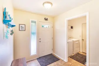 Welcoming entryway with laundry adjacent, leading to the oversize garage.