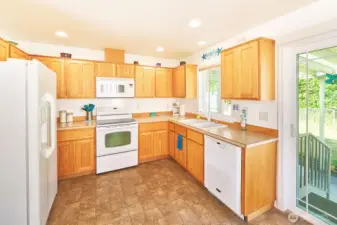 Kitchen has pretty cabinets and a functional layout.