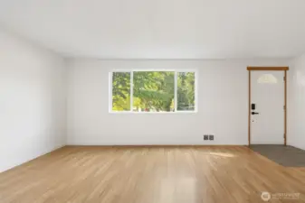 Living space with plenty of natural light. New wall heater and thermostat.