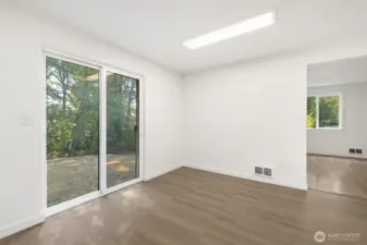 Large, open dining space in kitchen with sliding glass door to backyard.