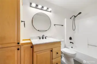 Updated bathroom with maple cabinets, new fixtures, new toilet and waterproof vinyl flooring.