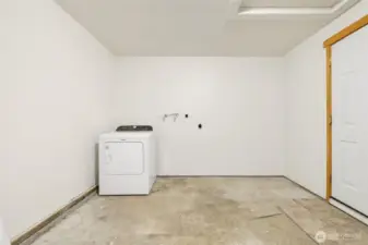 Freshly painted garage with new garage door opener, exterior key pad access, and new water valves for washing machine.