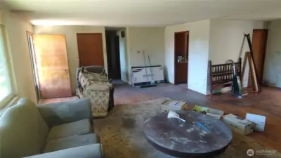 Living room towards hallway and front door