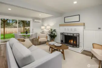 The bright lower level bonus room features a second wood burning fireplace, and new sliding glass door that steps out to the level back yard.
