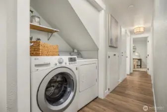 Laundry area is nicely tucked away under the stairs.