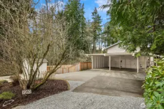 The expansive circular driveway ensures plentiful parking and smooth, convenient access.  Don't miss the spacious outdoor shed on the left!