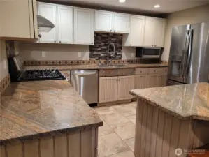 Lower unit kitchen with Stainless Steel appliances and granite counter tops