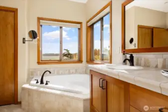 In the ensuite bath, treat yourself to a luxurious tub with a view. Completely private and serene.