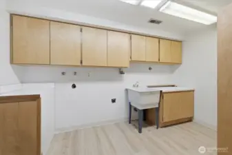 Huge laundryroom with tons of cabinet space, sink and conveinent laundry-chute.