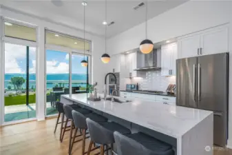 The chef’s kitchen includes an oversized island, custom cabinetry and a separate pantry.