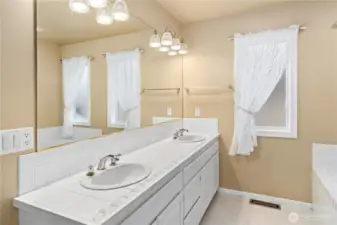 The primary bathroom has a soaking tub, shower, private water closet and lots of storage.