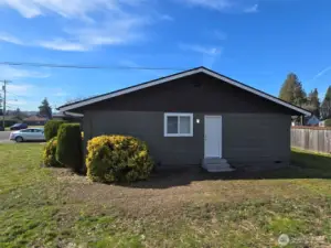 side of duplex showing door off the kitchen to the side yard.
