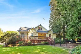 The large, flat yard includes a fenced dog run. Note the recently updated deck