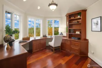 Built-in office space tucked into primary bed with fireplace and acreage views