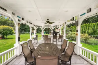 Tremendous covered outdoor living with lighting, suitable for large gatherings with commercial size pizza oven