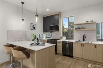 The chef’s kitchen shines with quartz countertops, pendant lighting, and sleek cabinetry that maximizes storage.