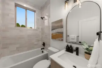 Designer powder bath with arched mirror and warm finishes creates a stylish touch for guests.