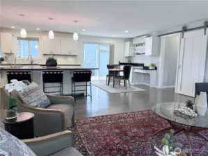 Barn door leads to laundry room and primary bedroom