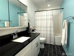 Hallway bathroom. Quartz countertops, tile floor