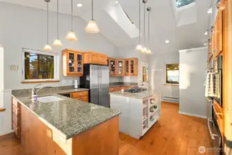 Granite surfaces and abundant cabinetry complement a functional layout designed to maximize natural light and stunning Smugglers Cove vistas.