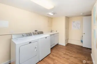 Spacious laundry area with storage and workspace, designed for convenience without compromising style.