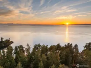 Unobstructed western views capture glowing sunsets and ever-changing skies over the Salish Sea.
