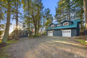 Detached multi-bay garage with studio apartment above, offering versatile guest space, creative use, or extended-stay flexibility.