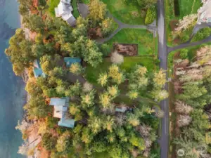 Top-down aerial showcasing the generous waterfront parcel, mature landscaping, and peaceful island privacy.