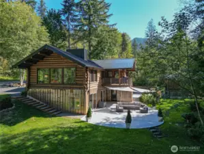 Cedar Logs from Church Mountain, Corten steel siding and medal roof. Sunny backyard and patio.