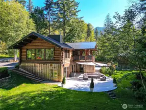 Cedar Logs from Church Mountain, Corten steel siding and medal roof. Sunny backyard and patio.