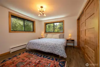 Main floor Primary Bedroom suite. Knotty alder doors flank the large closet.