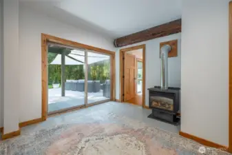 The lower level offers it's own entry and another primary suite,  mini-fridge, microwave, and coffee bar—perfect for extended guests or multigenerational stays. The expansive lower level also features a large rec room and is pre-plumbed for a future kitchenette or bar, presenting exceptional flexibility for guest quarters or entertainment space.