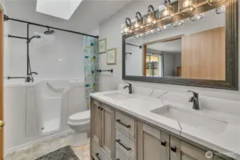 The newly remodeled primary bathroom has a walk-in tub/shower, new cabinets and lights plus there is easy access from the hallway too!